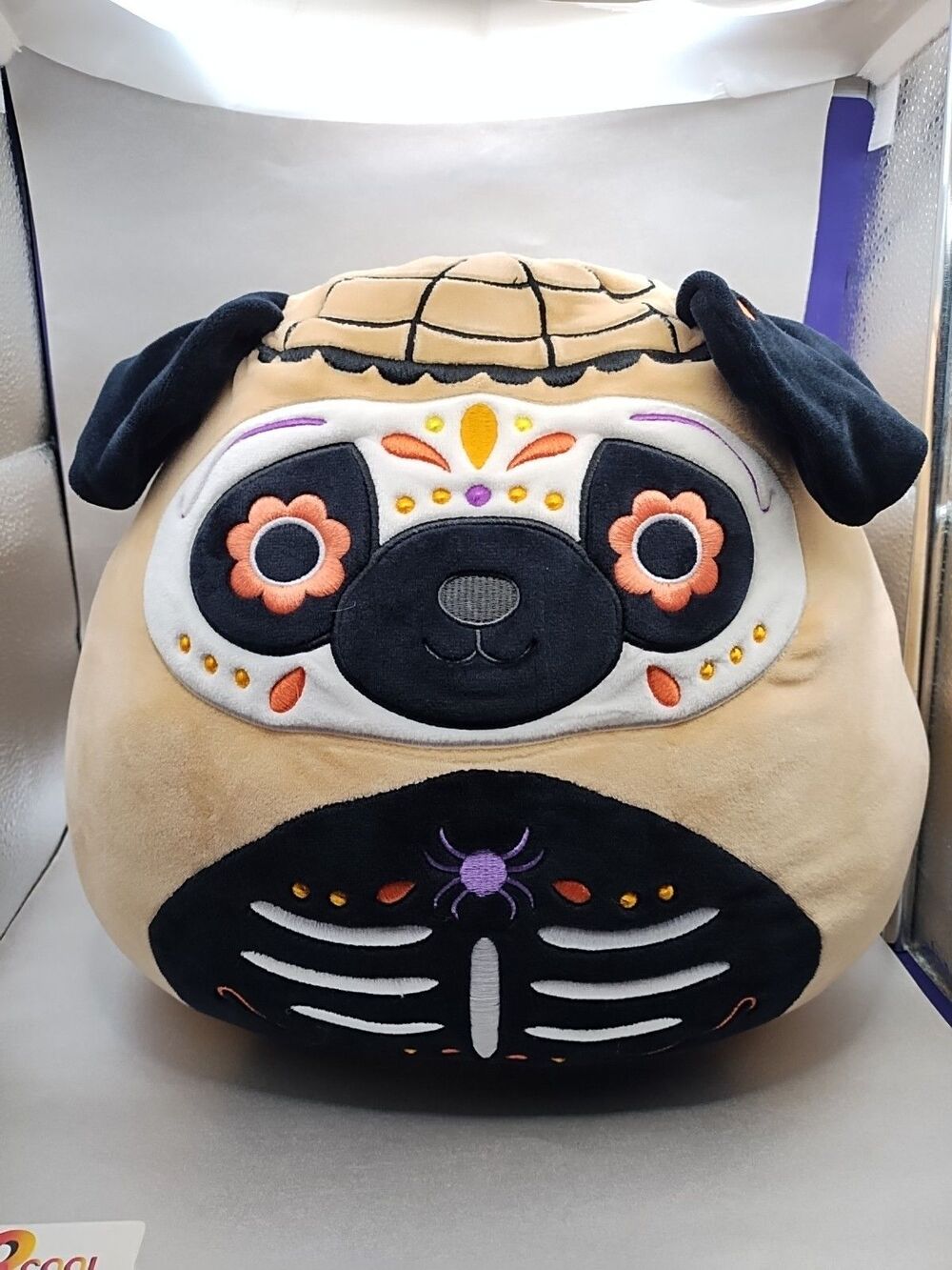 Squishmallows "Prince" the Pug plush, featuring a Day of the Dead (sugar skull)